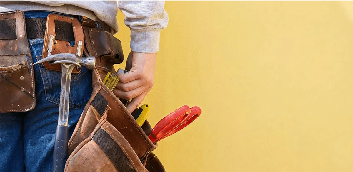 Handyman with tool belt ready for home repairs and maintenance in Ann Arbor, MI