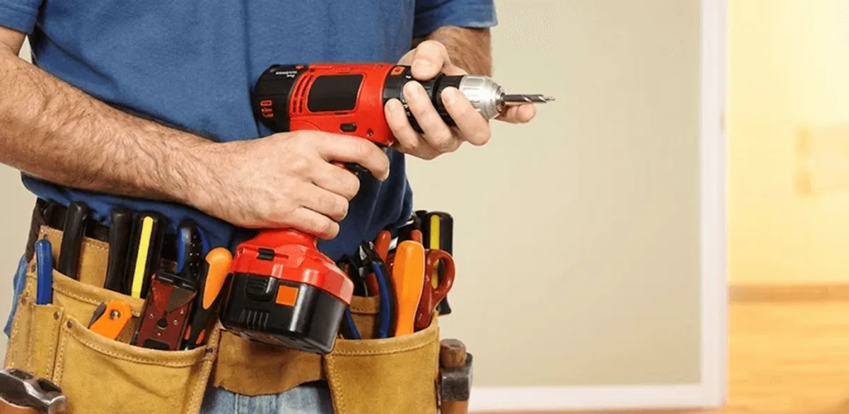 Handyman holding a power drill for home repairs and installations in Ann Arbor, MI